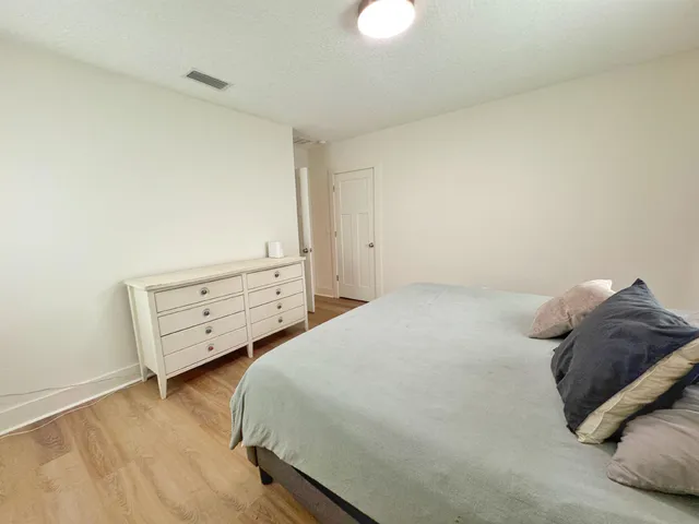 a bedroom with a bed and a night stand