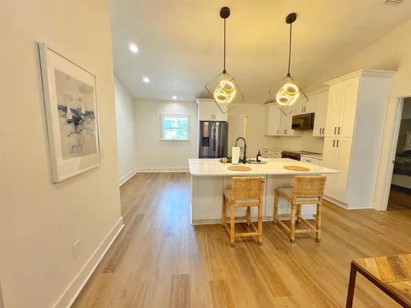 a view of a dining room with furniture and wooden floor