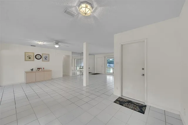 a view of a kitchen with a sink and a refrigerator