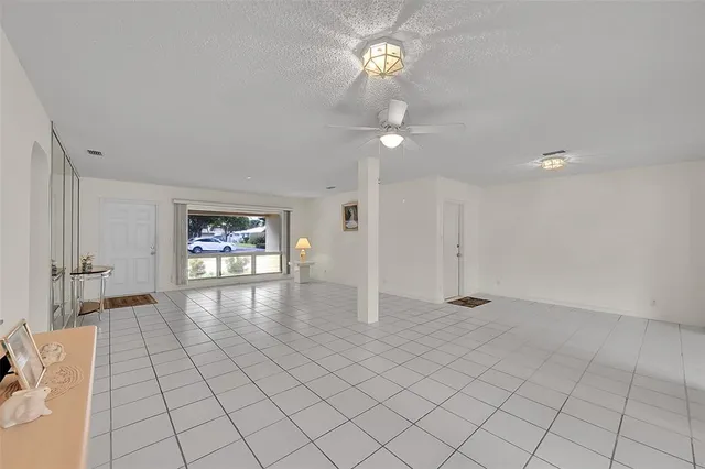 a kitchen with stainless steel appliances kitchen island granite countertop a sink a stove a refrigerator a dining table and chairs