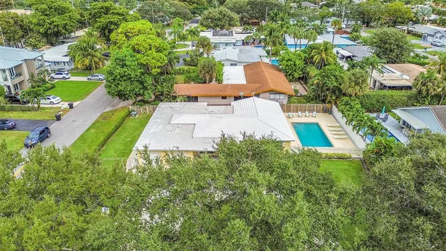 an aerial view of a house with outdoor space pool seating area and yard