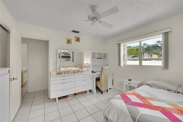 a view of house with swimming pool and seating area
