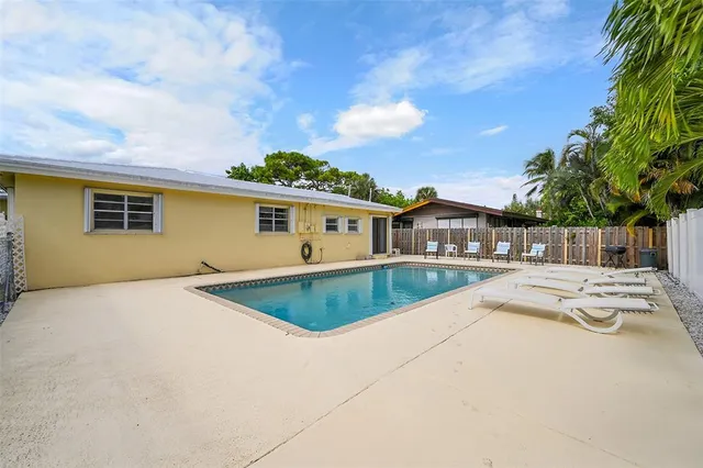 an aerial view of residential houses with outdoor space and trees