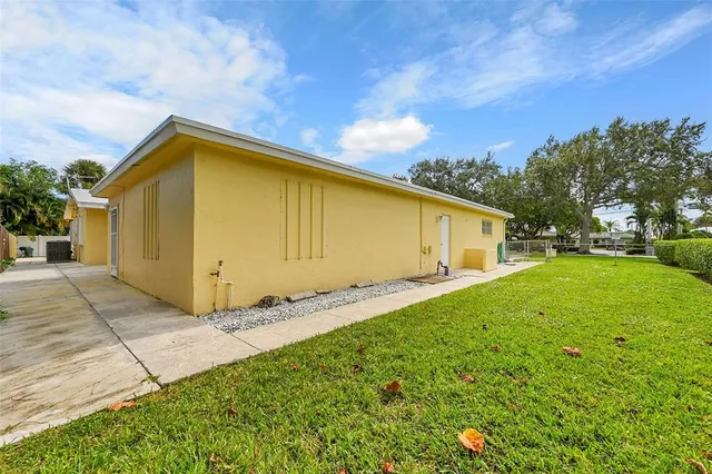 an aerial view of a house with a yard and trees