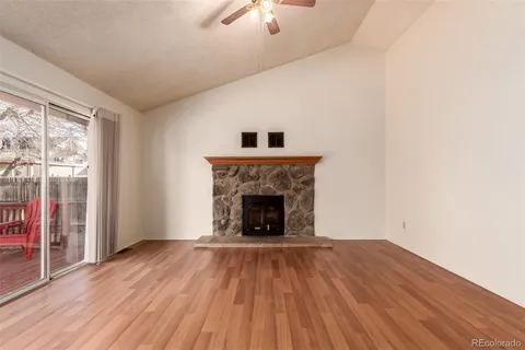wooden floor fireplace and natural light in room