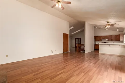 a view of a kitchen with a sink and a refrigerator
