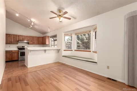 a view of a kitchen with a sink dishwasher and wooden floor