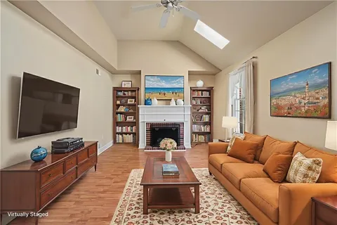 an empty room with windows and a fireplace