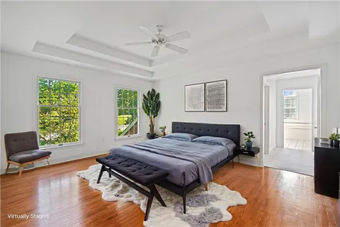 a bedroom with a bed and a flat screen tv