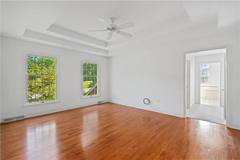 a view of an empty room with wooden floor