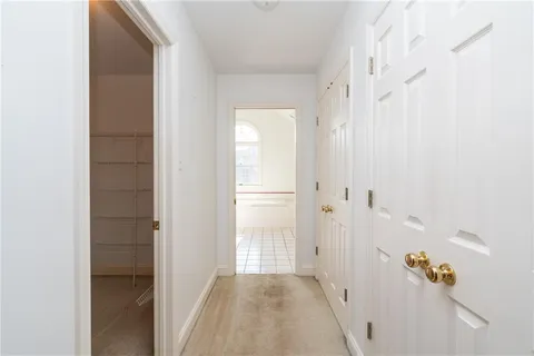 a bathroom with a granite countertop sink a large mirror and a bathtub