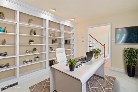 a living room with furniture and a potted plant