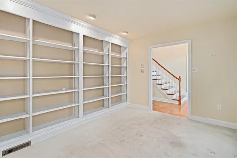 a view of an empty room with a cabinet and a window