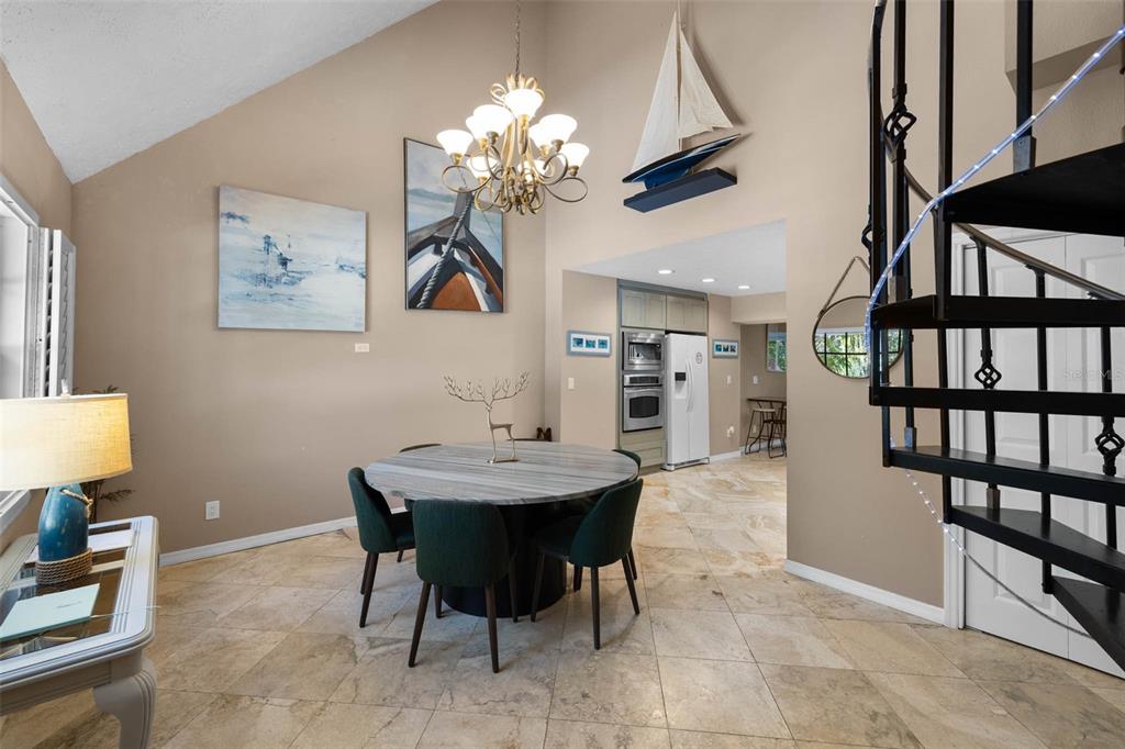 6110 Bear Trail Weeki Wachee, FL 34607 - Photo 12 of 48 a view of a dining room with furniture and a chandelier fan