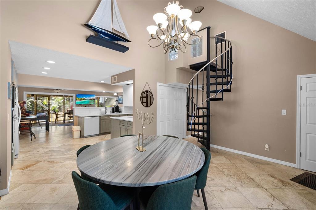 6110 Bear Trail Weeki Wachee, FL 34607 - Photo 13 of 48 a dining room with furniture a chandelier and wooden floor