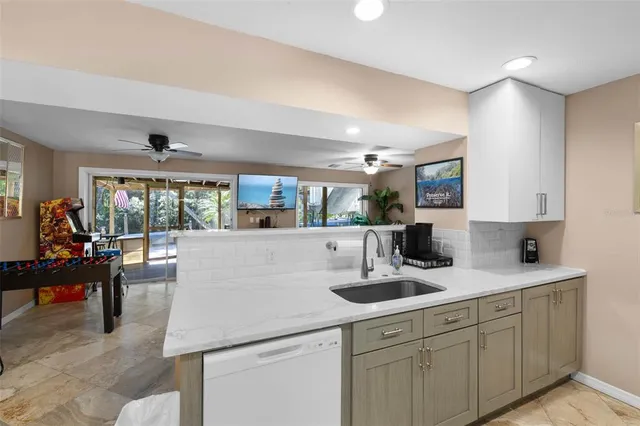a kitchen with stainless steel appliances a sink a stove and a refrigerator