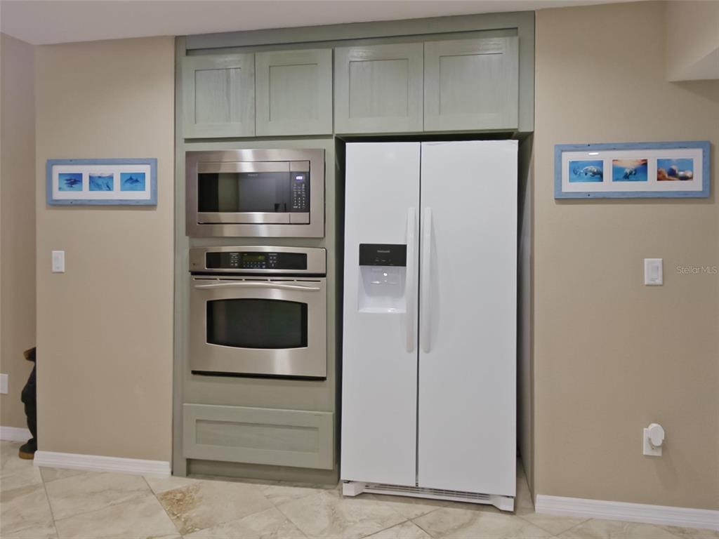 6110 Bear Trail Weeki Wachee, FL 34607 - Photo 17 of 48 a kitchen with a refrigerator and an oven