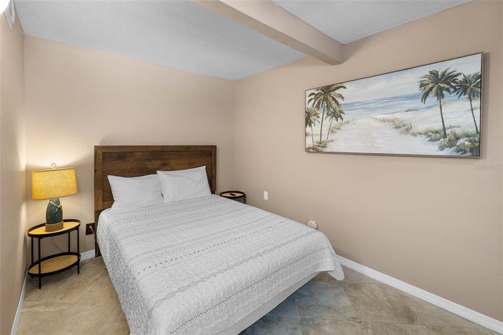 6110 Bear Trail Weeki Wachee, FL 34607 - Photo 21 of 48 a bedroom with a bed and lamp