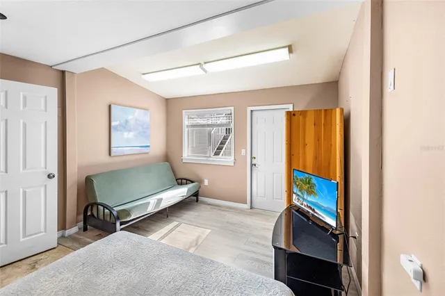a picture of a living room with furniture and wooden floor
