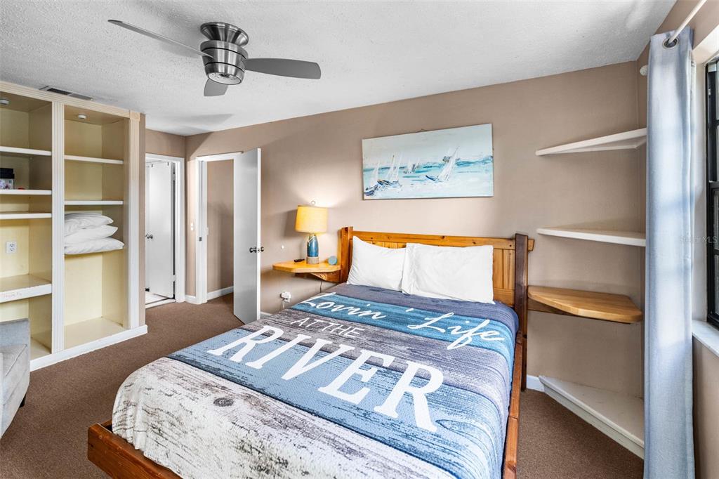 6110 Bear Trail Weeki Wachee, FL 34607 - Photo 29 of 48 a bedroom with a large bed and a chandelier