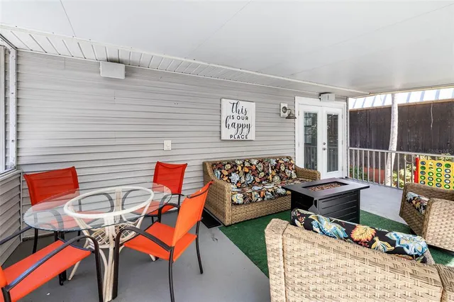 a view of yard from deck with patio