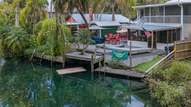 a view of a patio with couches table and chairs with wooden floor