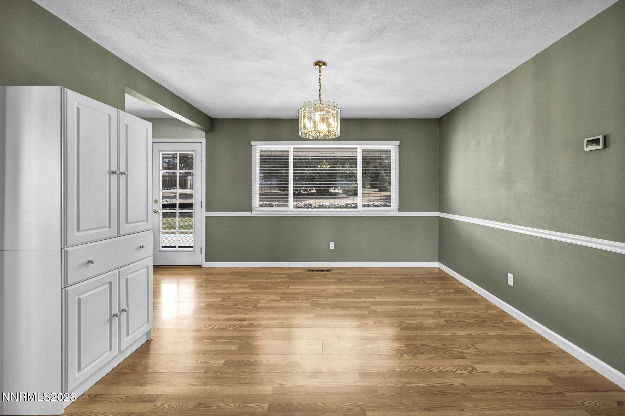 14190 Rim Rock Drive Reno, NV 89521 - Photo 16 of 68 a view of empty room with wooden floor and fan