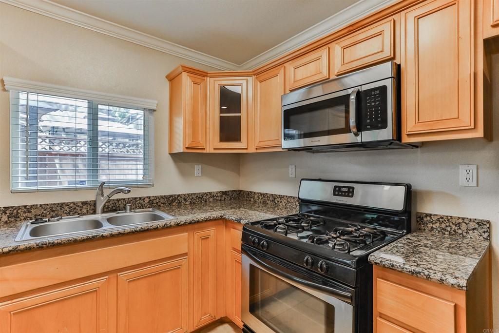 1133 Persimmon Avenue, Unit 7 El Cajon, CA 92021 - Photo 15 of 29 a kitchen with granite countertop cabinets stainless steel appliances and a sink