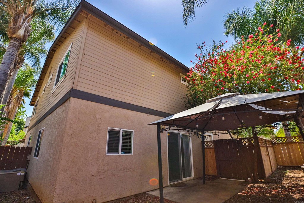1133 Persimmon Avenue, Unit 7 El Cajon, CA 92021 - Photo 20 of 29 a backyard of a house with an outdoor space and trees