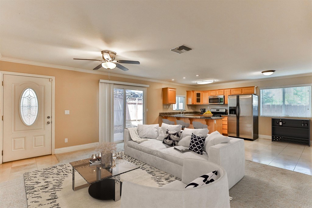 1133 Persimmon Avenue, Unit 7 El Cajon, CA 92021 - Photo 2 of 29 a living room with furniture a large window with kitchen view