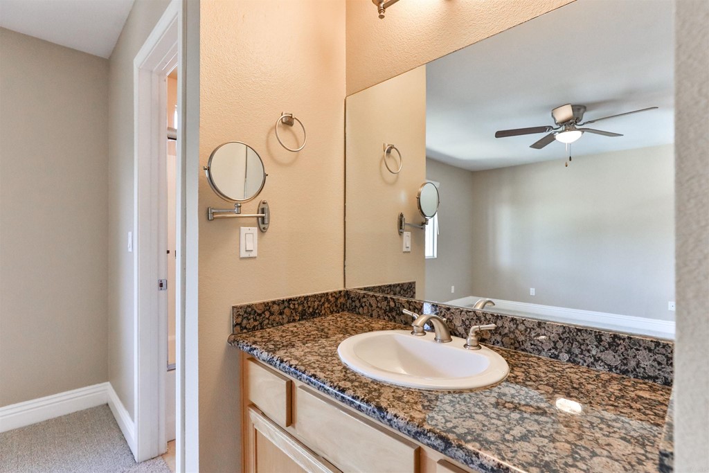 1133 Persimmon Avenue, Unit 7 El Cajon, CA 92021 - Photo 26 of 29 a bathroom with a granite countertop sink and a mirror