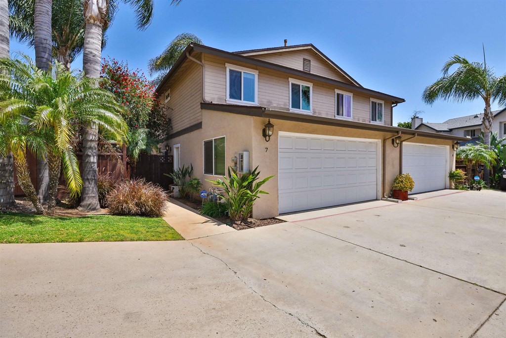 1133 Persimmon Avenue, Unit 7 El Cajon, CA 92021 - Photo 5 of 29 a front view of a house with a yard and garage