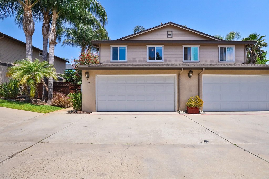 1133 Persimmon Avenue, Unit 7 El Cajon, CA 92021 - Photo 6 of 29 a front view of a house with a yard and garage