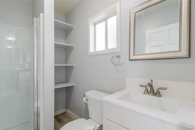 a white toilet sitting next to a bathroom sink