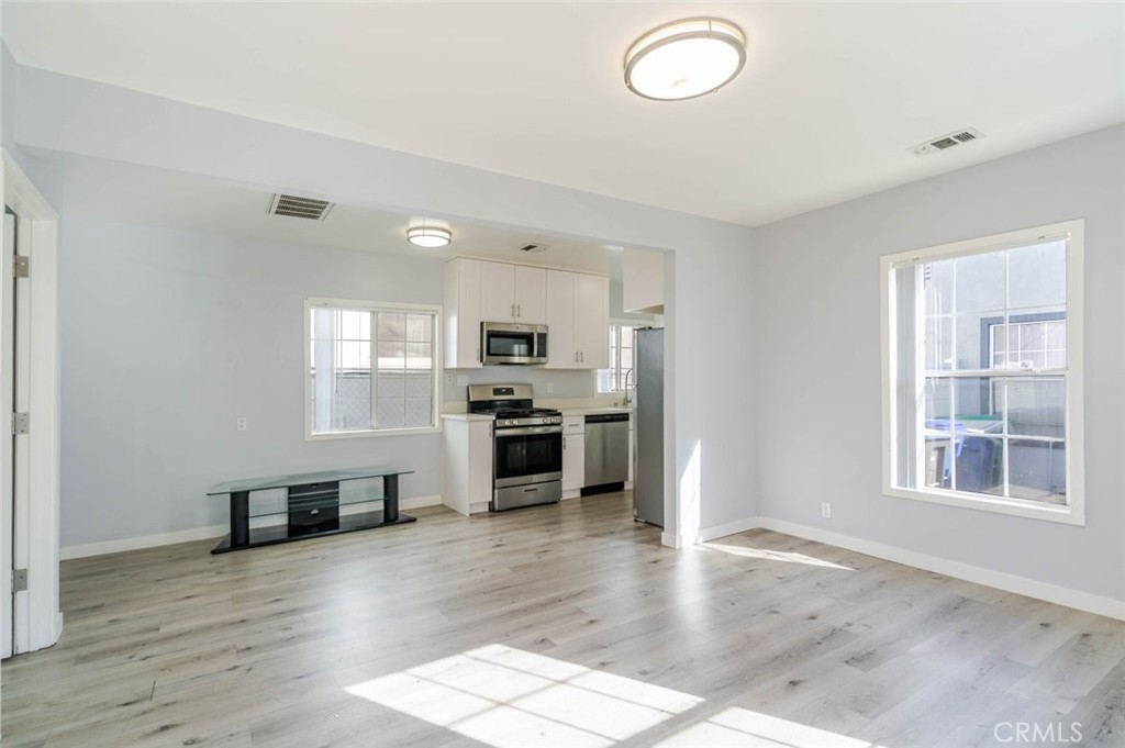 301 East Alameda Avenue, Unit A Burbank, CA 91502 - Photo 3 of 18 a kitchen with a refrigerator and a stove top oven