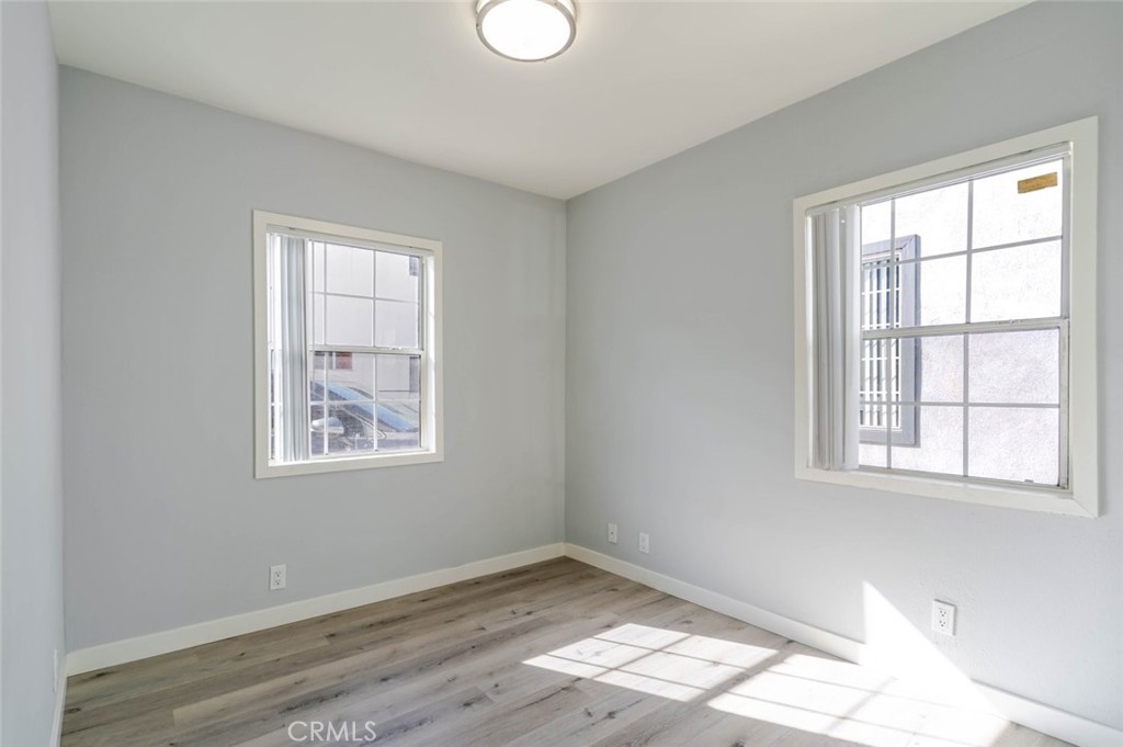 301 East Alameda Avenue, Unit A Burbank, CA 91502 - Photo 10 of 18 a view of an empty room with wooden floor and a window