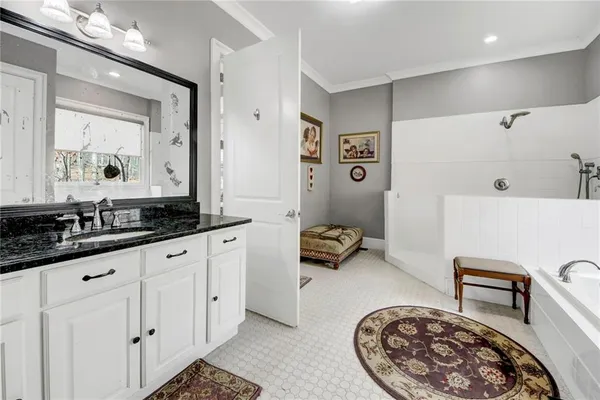 a spacious bathroom with a double vanity sink and a mirror