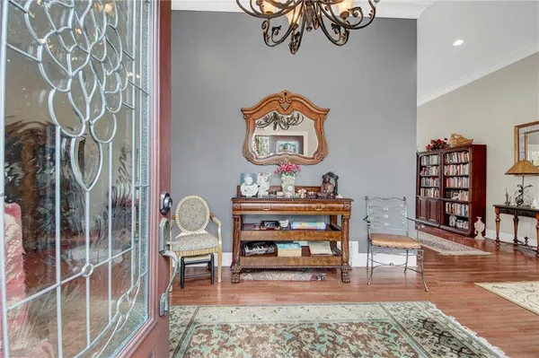 a view of a dinning room and livingroom with furniture and wooden floor