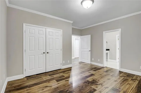 a view of an empty room with wooden floor