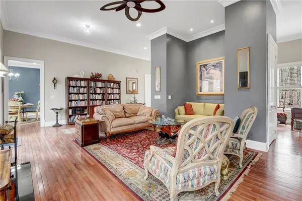 a living room with furniture and wooden floor