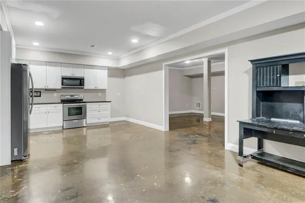 a view of kitchen with sink oven and cabinets