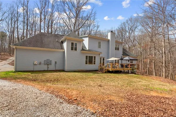 a view of a house with a yard covered in snow