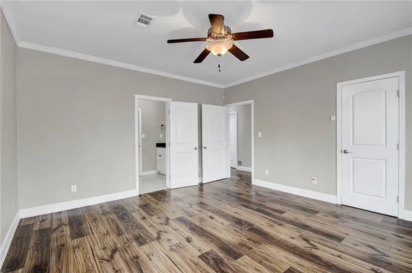 a view of an empty room with wooden floor