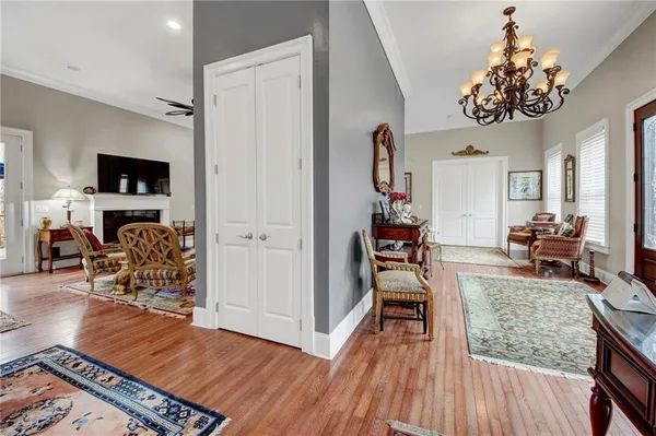 a view of a livingroom with furniture a flat screen tv and wooden floor