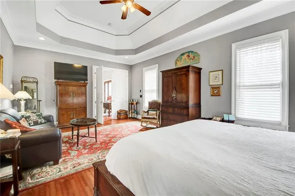 a large bedroom with furniture and a large window