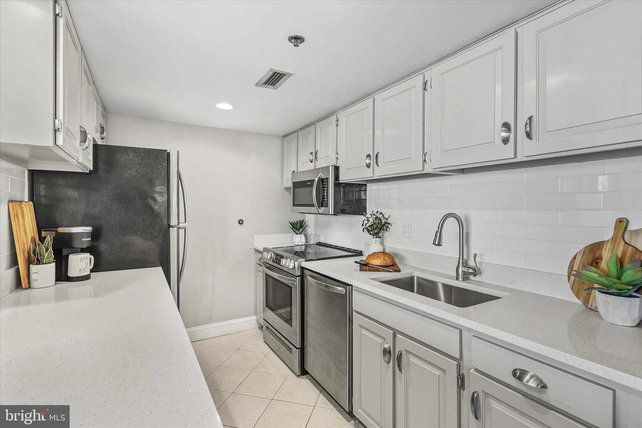 209 Georgetown House Road Bethany Beach, DE 19930 - Photo 11 of 57 a kitchen with stainless steel appliances granite countertop a sink a stove and a refrigerator