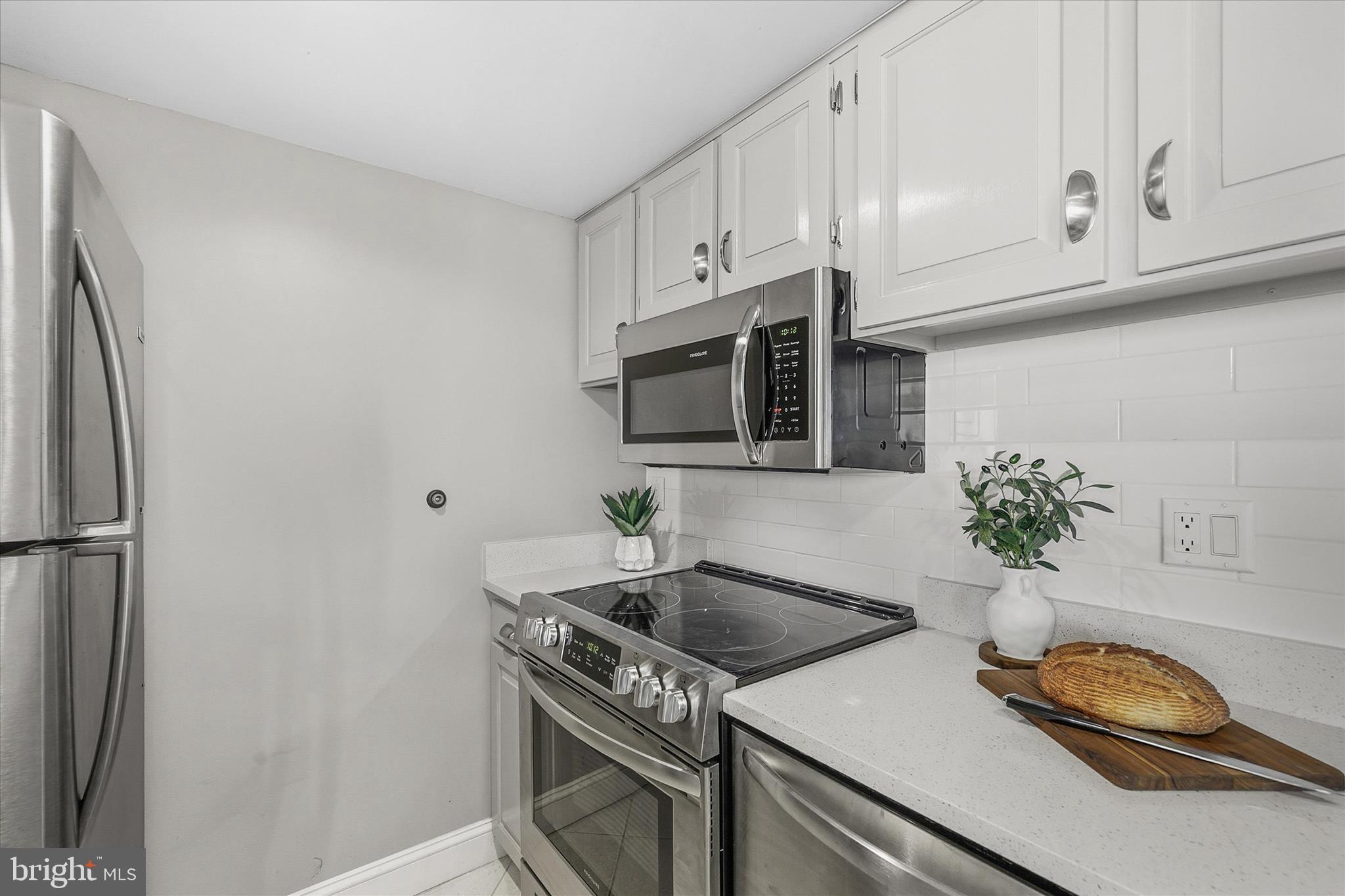 209 Georgetown House Road Bethany Beach, DE 19930 - Photo 14 of 57 a kitchen with stainless steel appliances granite countertop a sink a stove a microwave and refrigerator