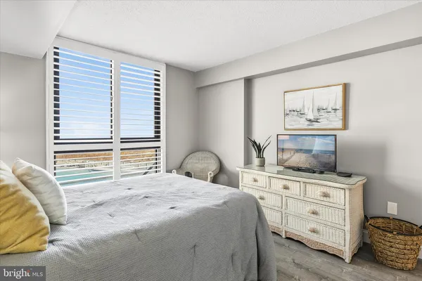 a bedroom with a bed and a television