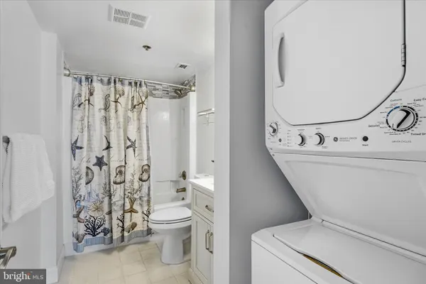 a bathroom with a sink toilet a mirror and shower curtain