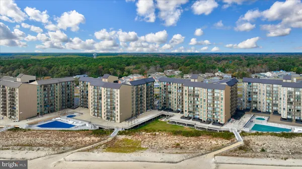 a view of a house with a swimming pool and sitting area